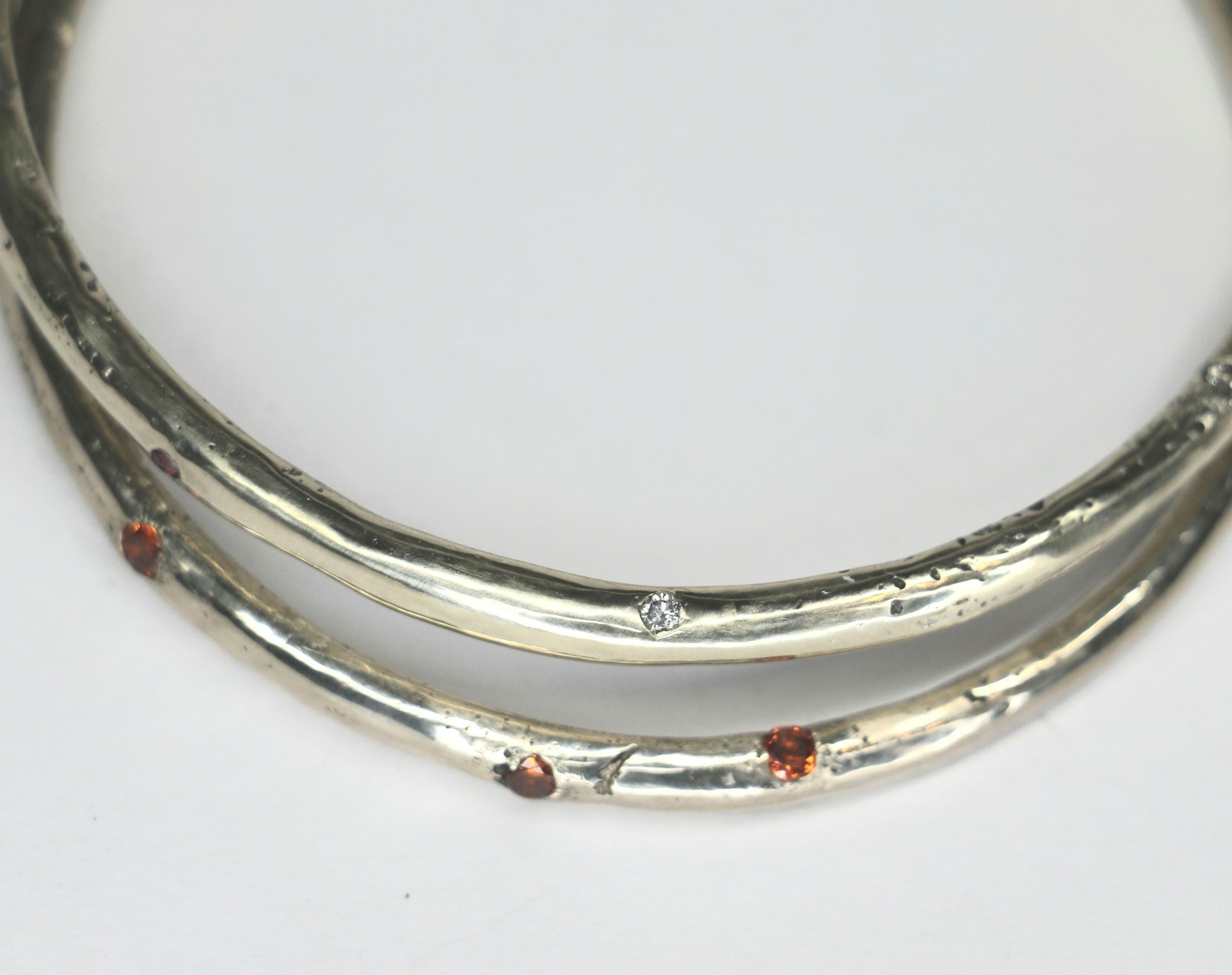 Sandcast bangle textured with gemstones