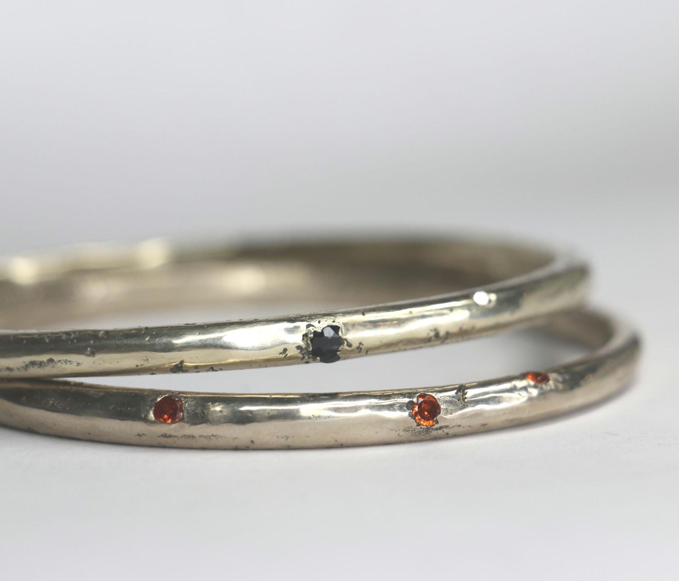 Sandcast bangle textured with gemstones