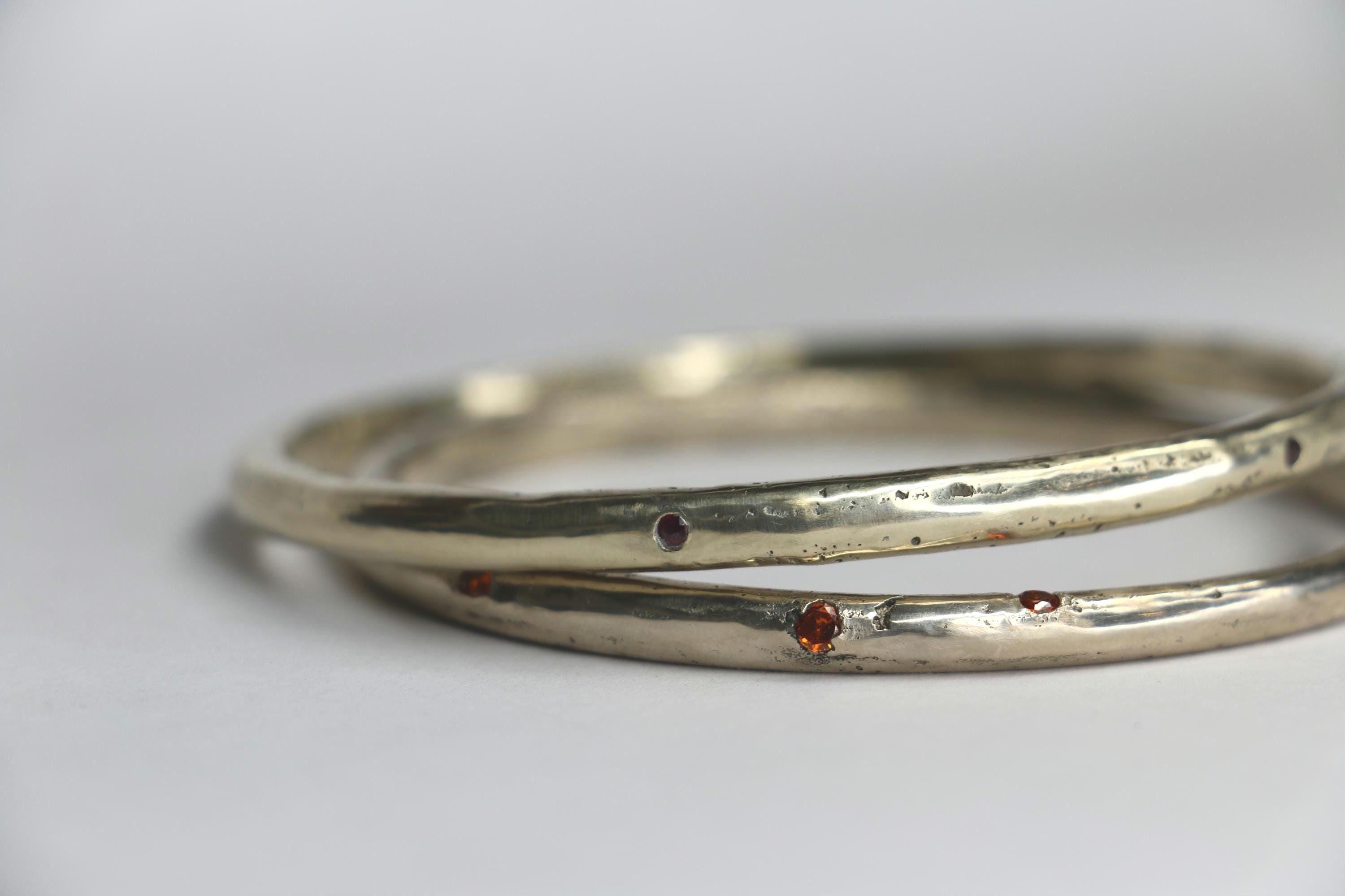 Sandcast bangle textured with gemstones