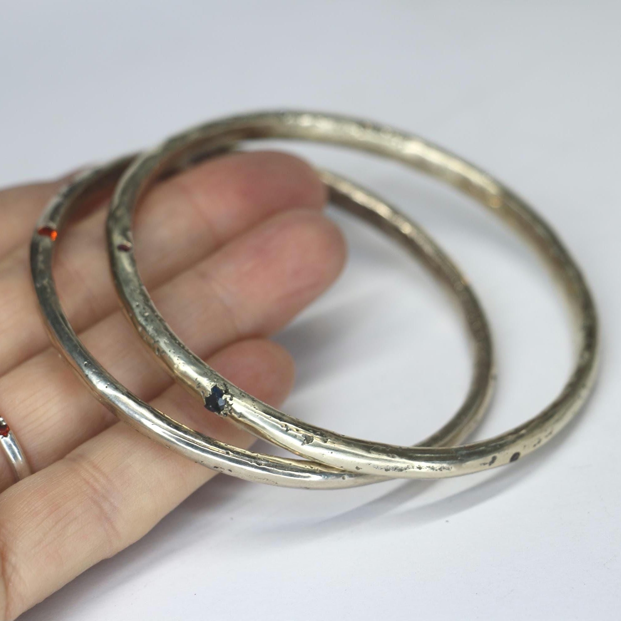 Sandcast bangle textured with gemstones